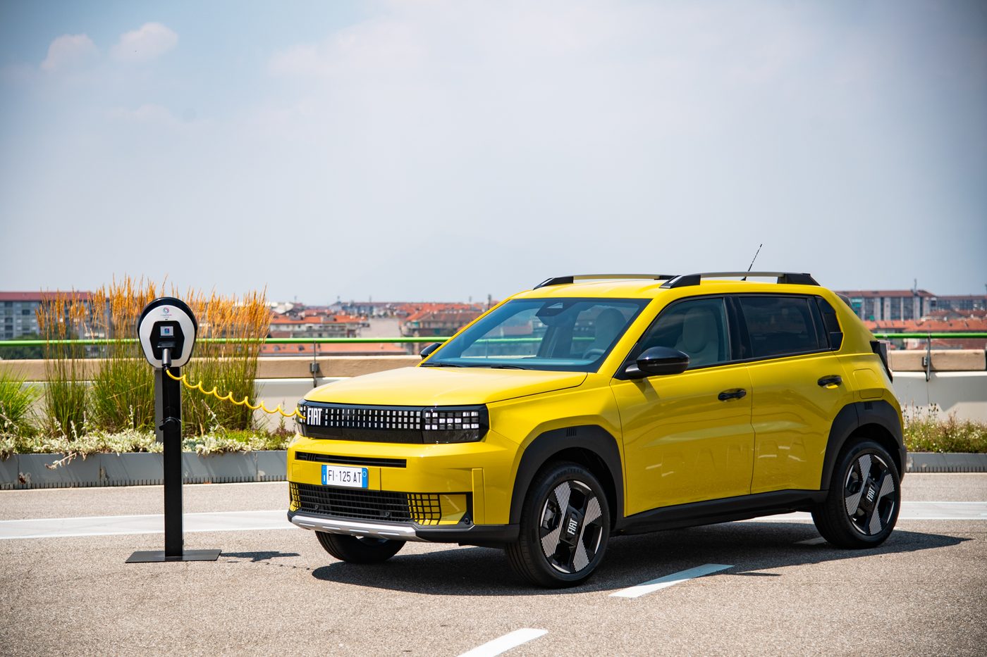 FIAT Grande Panda at a charging post on a rooftop car park